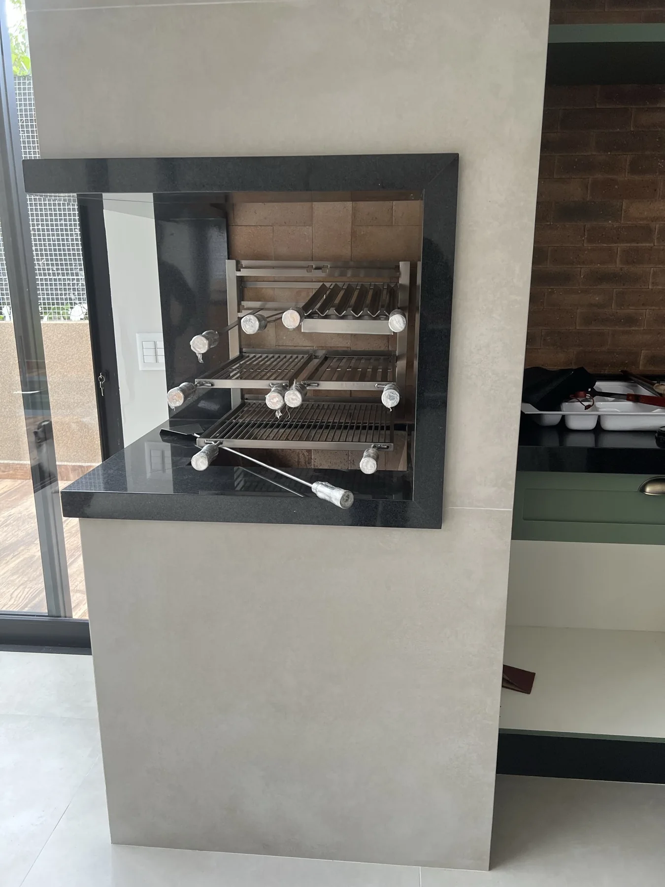 Grill Ossoboca em inox 304 instalado em nicho residencial com granito preto